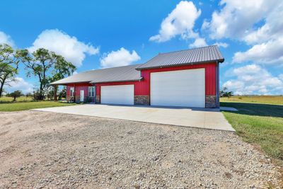 Garage featuring a yard | Image 2