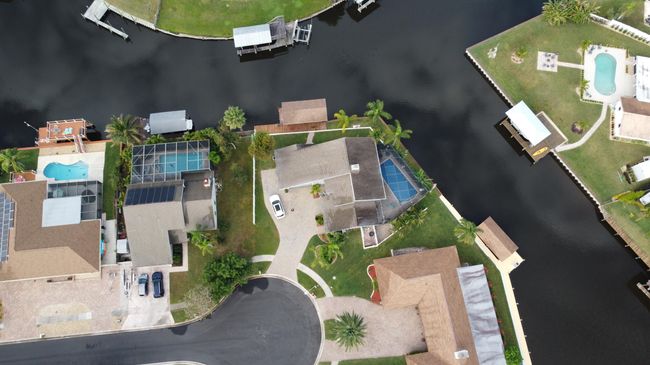 Surrounded by canal, fenced for privacy, private oasis with 154 feet of seawall, with Sykes Creek just around to the right. | Image 5
