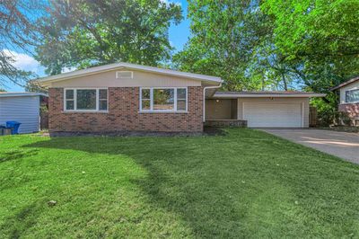 View of front of house with a garage and a front yard | Image 1