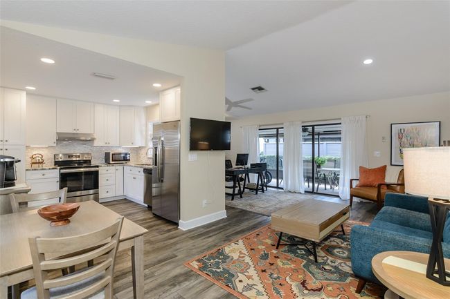 Cathedral ceilings add to the open floor plan. Foyer opens to kitchen, great room, and office/dining room. Laundry room is also off of the foyer. | Image 4
