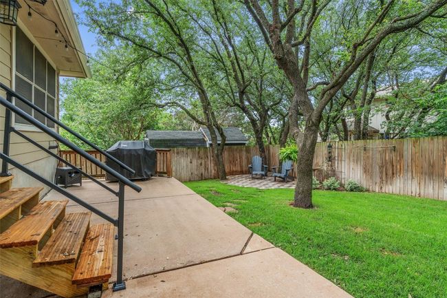 Fenced backyard featuring a patio and stairway | Image 32