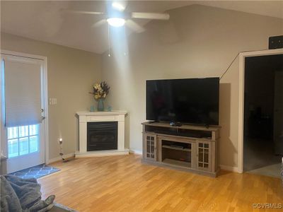 Unfurnished living room with vaulted ceiling, light hardwood / wood-style floors, and ceiling fan | Image 3