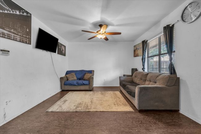 Living area with ceiling fan and baseboards | Image 4