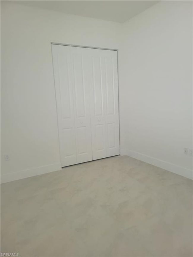 Unfurnished bedroom with baseboards and a closet | Image 21