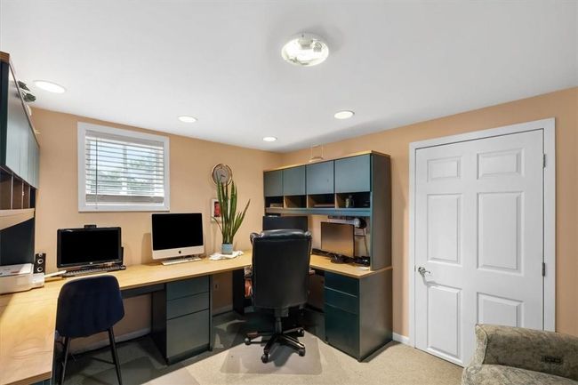 Basement office featuring built in desk | Image 24