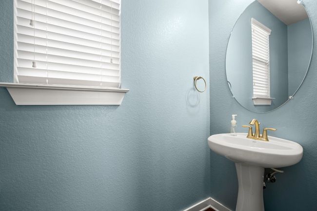 The half bathroom provides a simple and convenient space, perfect for everyday use or guests. | Image 11