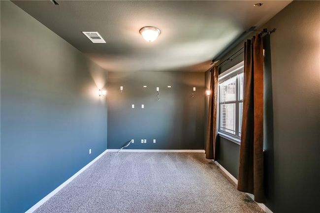 Carpeted empty room featuring baseboards | Image 24