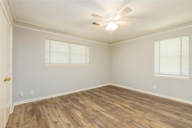 Main Bedroom has recent wood laminate flooring and recent light fixture | Image 15