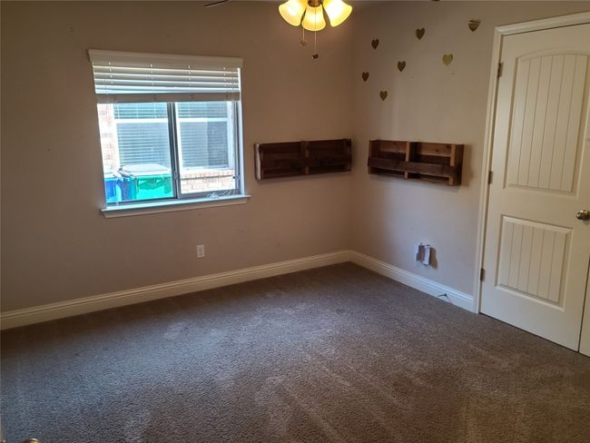 Carpeted spare room featuring baseboards and a ceiling fan | Image 21