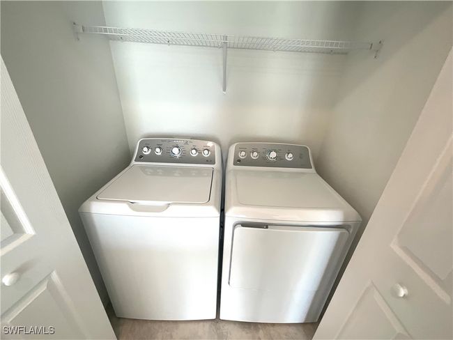 Washroom featuring separate washer and dryer and wood finished floors | Image 18
