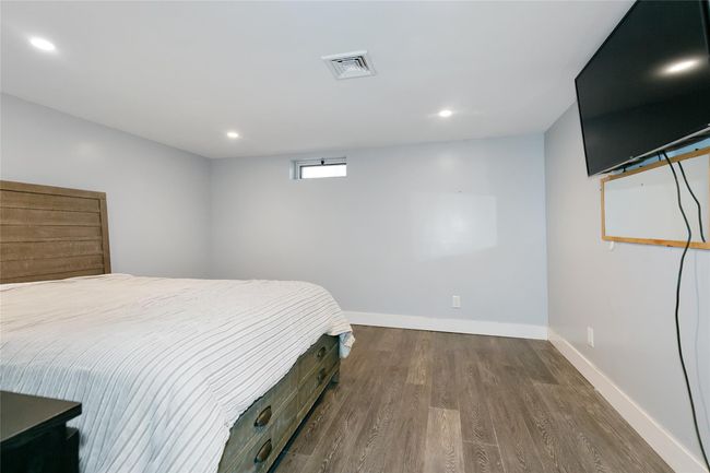 Bedroom with baseboards, visible vents, dark wood-type flooring, and recessed lighting | Image 22