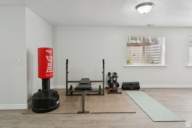 Workout area with healthy amount of natural light, wood finished floors, and baseboards | Image 24