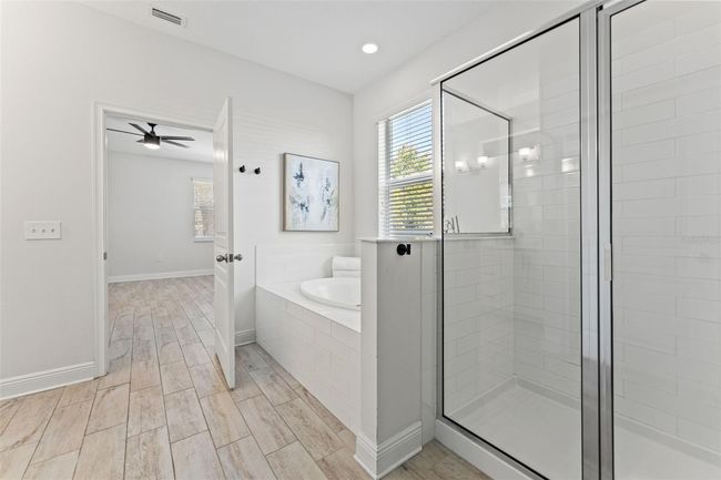 Primary bathroom on first floor with tub & shower | Image 19
