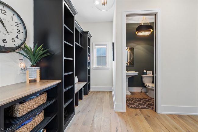 Spacious closet with light wood-type flooring | Image 14