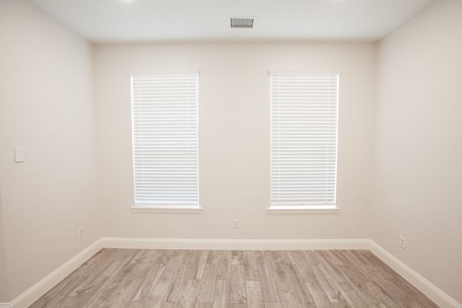 Spare room featuring light wood-type flooring and baseboards | Image 8