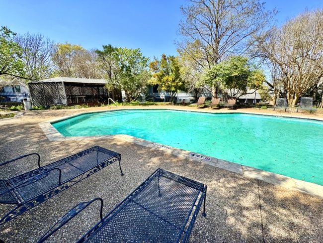 The community pool has lounge chairs. | Image 19