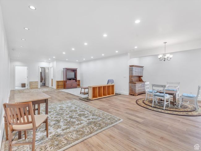 Living area featuring a notable chandelier, recessed lighting, and light wood-style floors | Image 28
