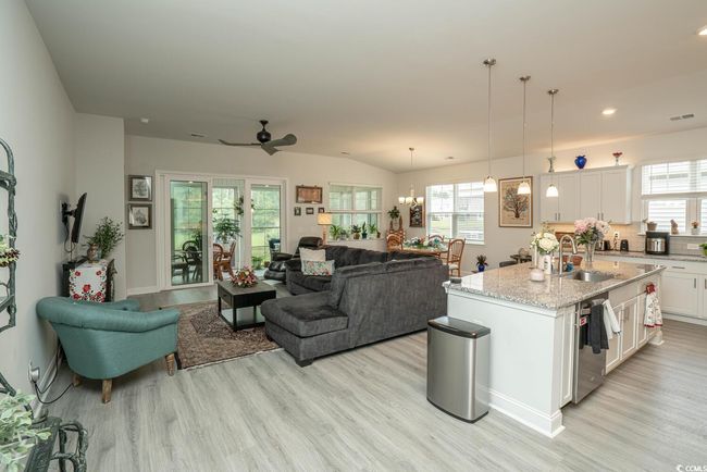 Living room featuring light wood-style floors, ceiling fan, and recessed lighting | Image 21