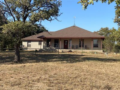 View of front of home with a porch and a front yard | Image 1