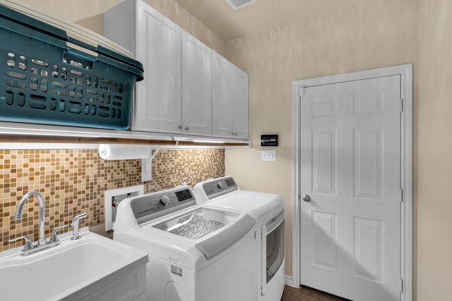 Full size laundry room with cabinets and sink | Image 32