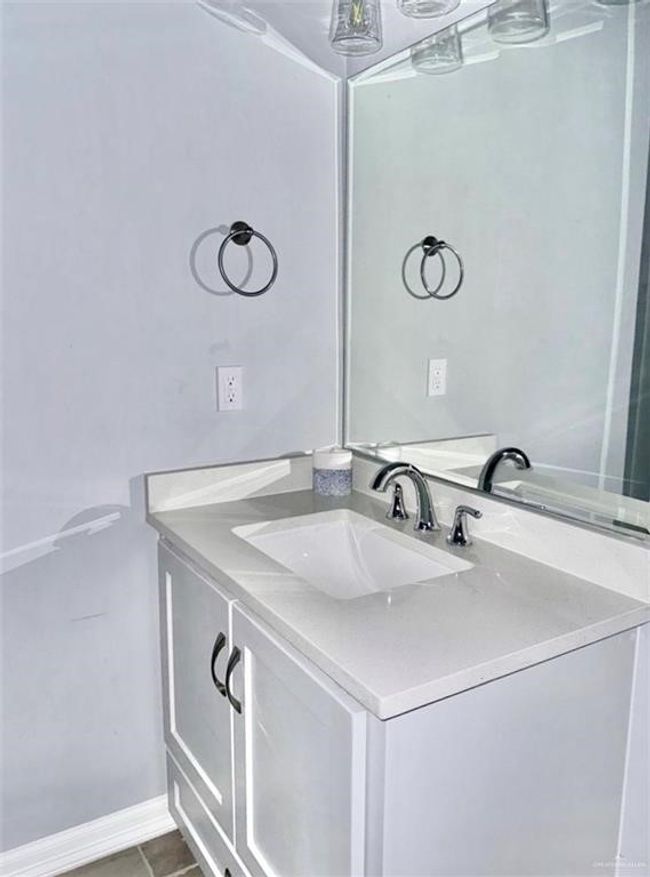 Bathroom with vanity, baseboards, and tile patterned floors | Image 8