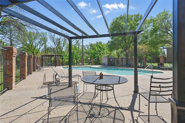 Pool featuring a patio area, fence, a storage shed, and an outbuilding | Image 21