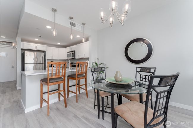 The open floor plan allows for casual meals at the eating bar, gathering in the dining area or dining al fresco on the balcony | Image 10
