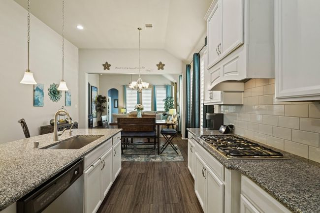 This adaptable home offers seamless flow between living spaces, perfect for creating an open-concept design connecting a modern kitchen, inviting dining area, and comfortable living room, all bathed in natural light. | Image 10