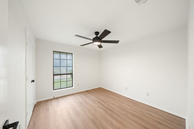 Bedroom with baseboards, ceiling fan, and walk in closet | Image 19