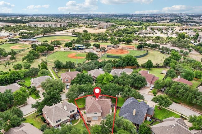 Situated on a spacious lot in a serene, tree-lined neighborhood. | Image 9