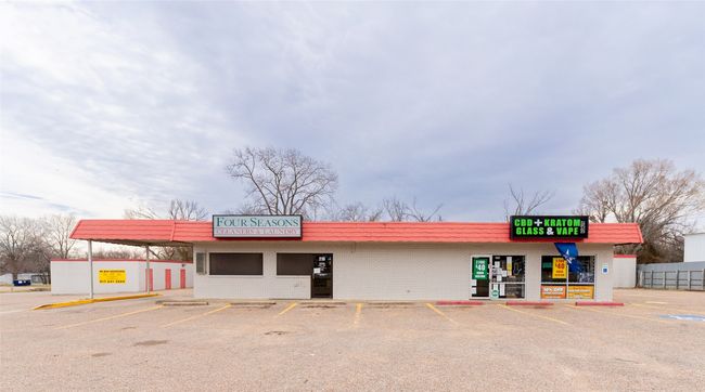 View from front of property featuring retail in front building and mini warehouse spaces in back of property. | Image 11