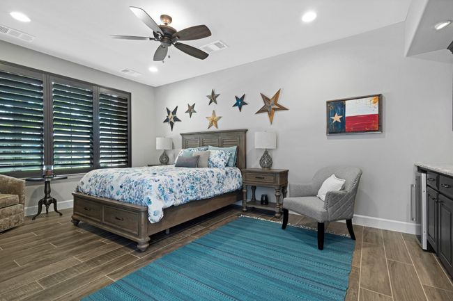Bedroom with wood finish floors, baseboards, a ceiling fan, and recessed lighting | Image 18