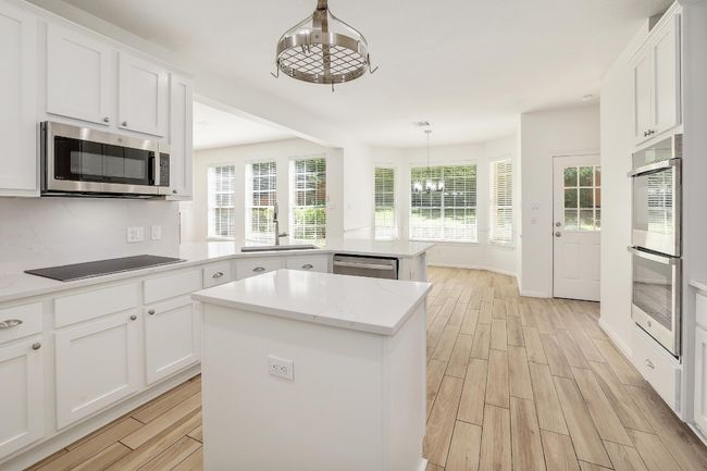 Gourmet Kitchen with Quartz Countertops and Stainless Steel Appliances and Island | Image 12
