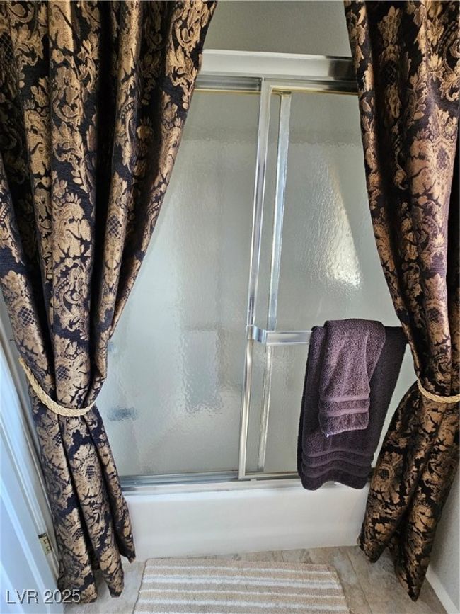Bathroom featuring combined bath / shower with glass door | Image 18