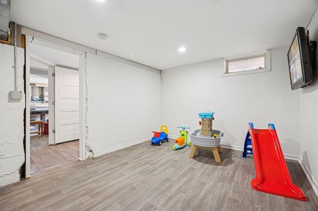 The lower-level bedroom offers versatile potential, perfect for use as an office, guest room, play room, or any other space to suit your needs. | Image 16