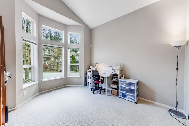 Carpeted office with visible vents, baseboards, and high vaulted ceiling | Image 12