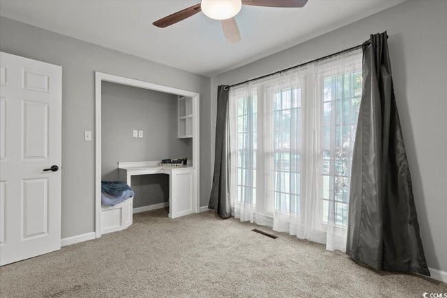 Unfurnished bedroom featuring light carpet, ceiling fan, and baseboards | Image 19