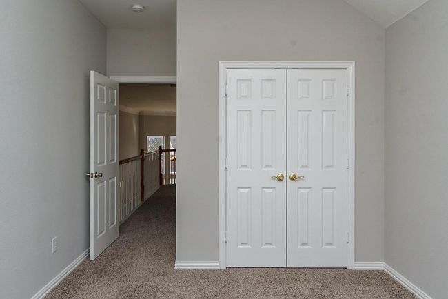 Unfurnished bedroom with lofted ceiling, a closet, carpet flooring, and baseboards | Image 24