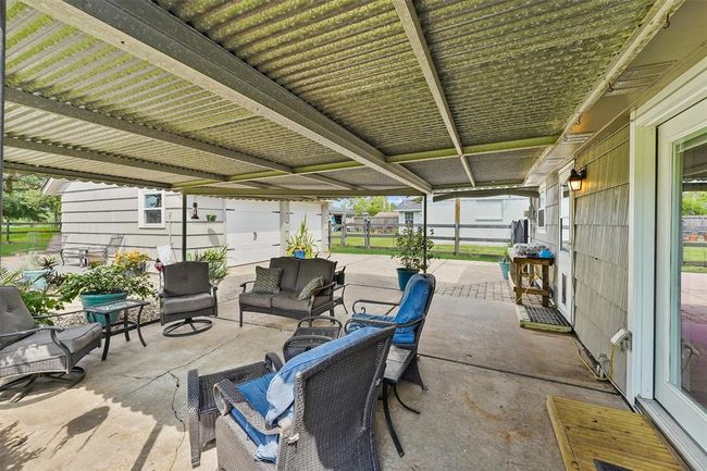 Relax or entertain year-round under the spacious covered patio—perfect for morning coffee or evening wine with a view. | Image 21