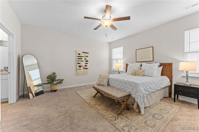 Bedroom featuring light carpet, ceiling fan, and baseboards | Image 28