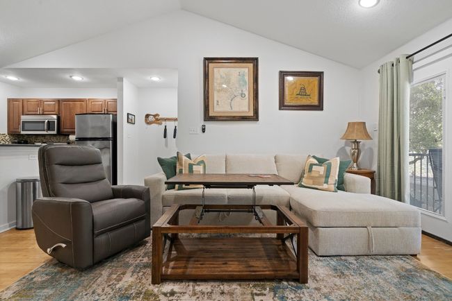 Living area featuring vaulted ceiling, light wood-style flooring, and recessed lighting | Image 11