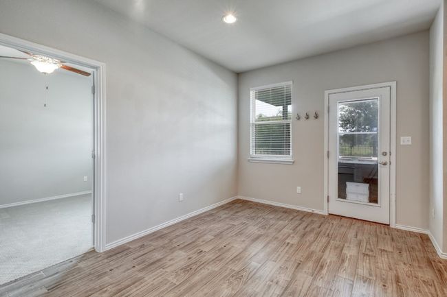 Empty room featuring light wood-type flooring, ceiling fan, and recessed lighting | Image 11