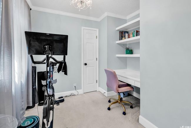 Office space with light carpet, a chandelier, and crown molding | Image 19