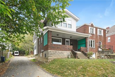 Large covered porch - quiet side street access to garage | Image 2