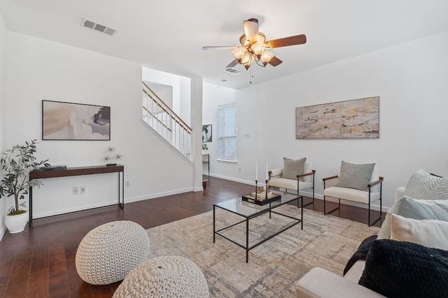 Living room featuring stairway, a ceiling fan, wood finished floors, and baseboards | Image 6