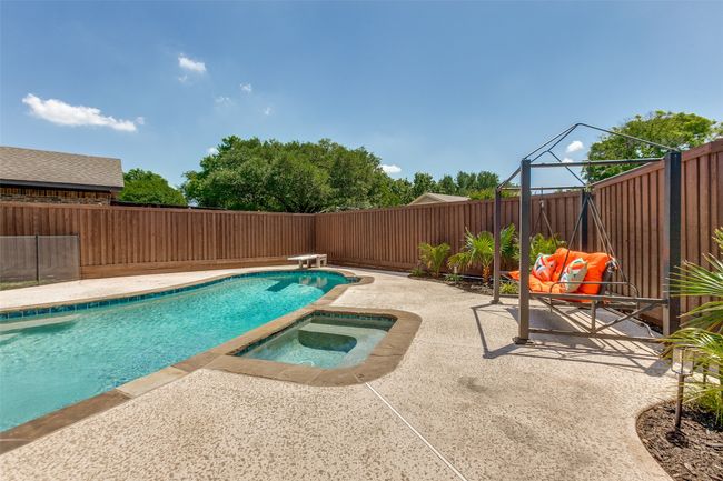View of pool featuring an in-ground hot tub, a patio area, a fenced backyard, and a diving board | Image 35