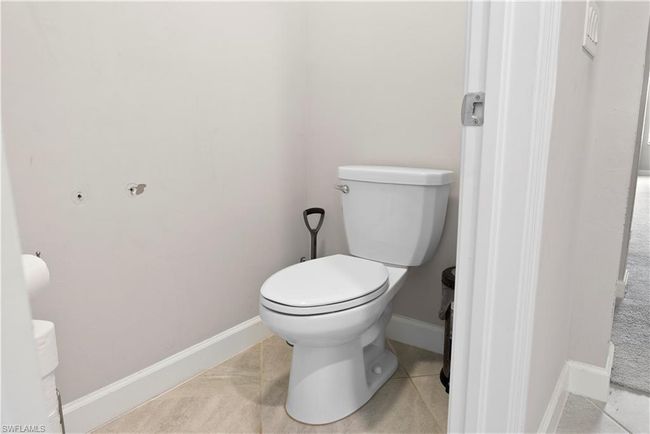 Bathroom with baseboards, toilet, and tile patterned flooring | Image 25