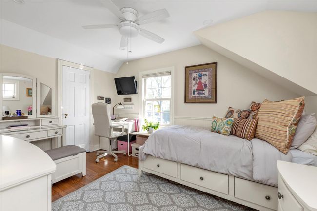Bedroom featuring vaulted ceiling, wood finished floors, and ceiling fan | Image 8