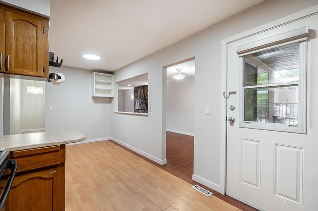 Kitchen featuring brown cabinetry, light wood-style floors, stainless steel range, and light countertops | Image 10