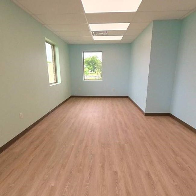 Spare room with a paneled ceiling, baseboards, and light wood-style floors | Image 6